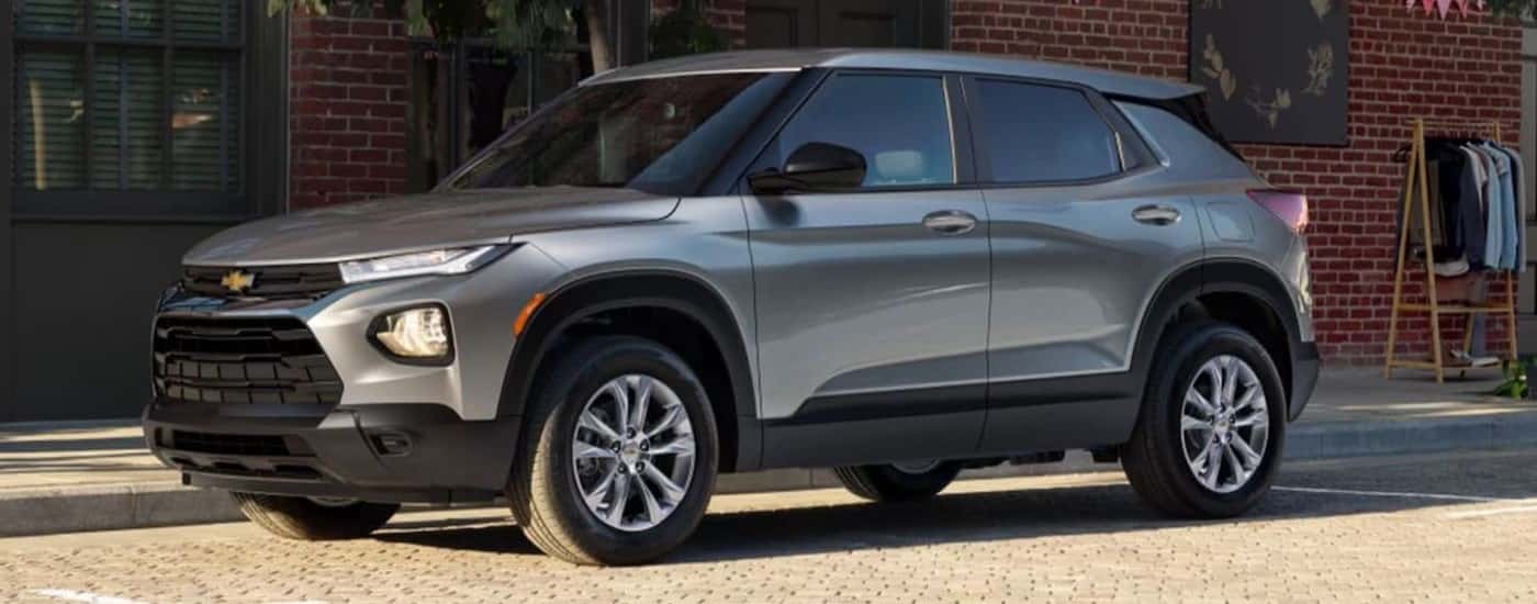 A grey 2023 Chevy Trailblazer is parked on the side of a city street.
