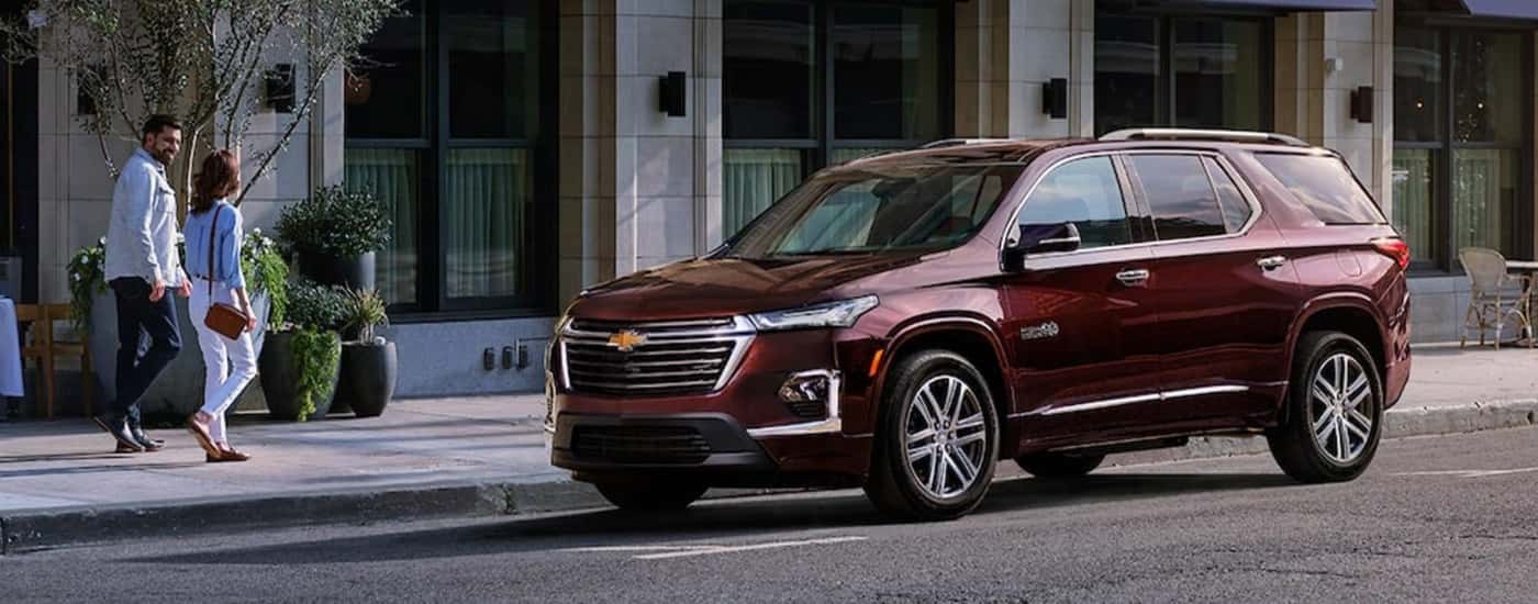 A maroon 2022 Chevy Traverse High Country is parked on the side of a city street after leaving a used car dealer near Haverhill.