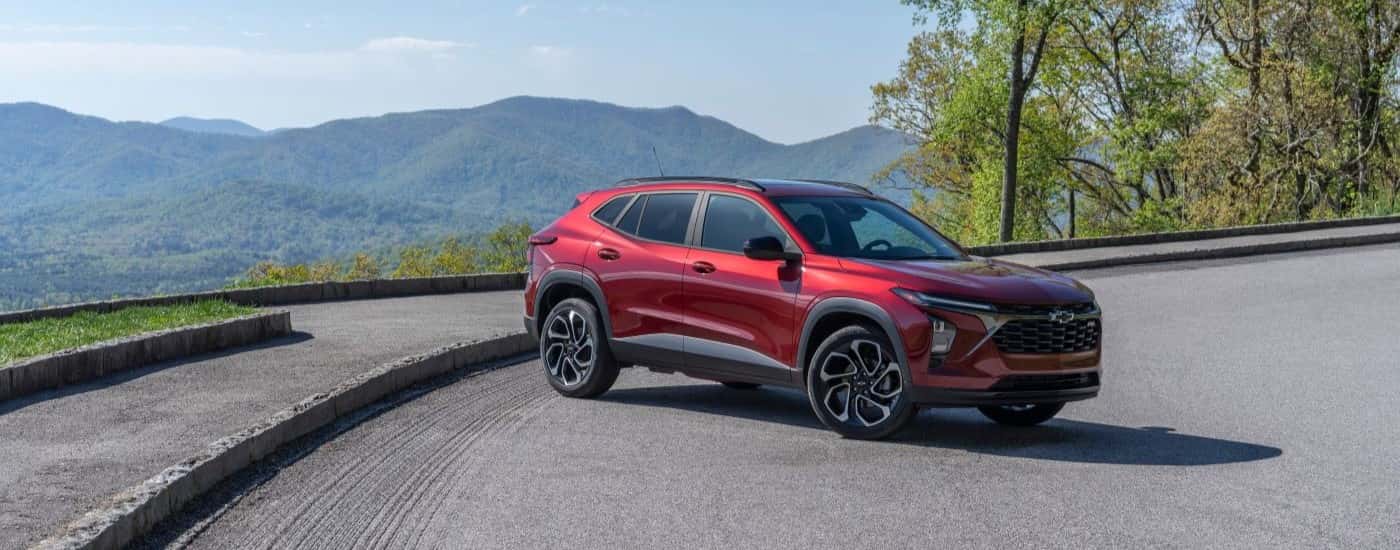 A red 2024 Chevy Trax RS parked at a scenic overlook