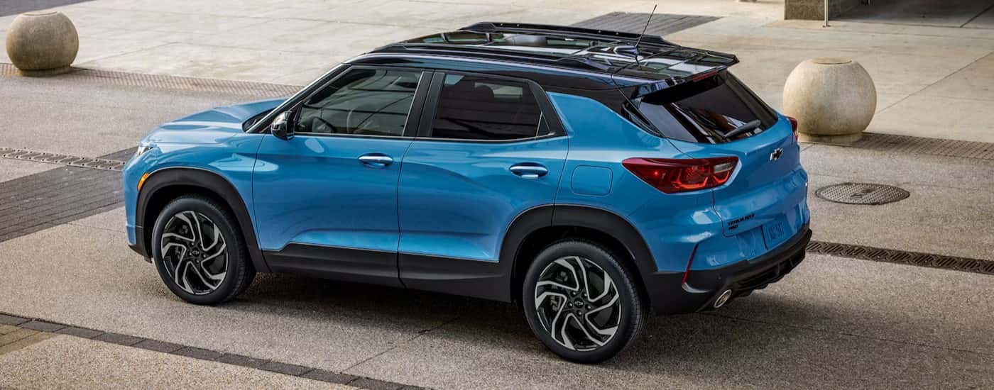 A blue 2025 Chevy Trailblazer RS parked in a city.