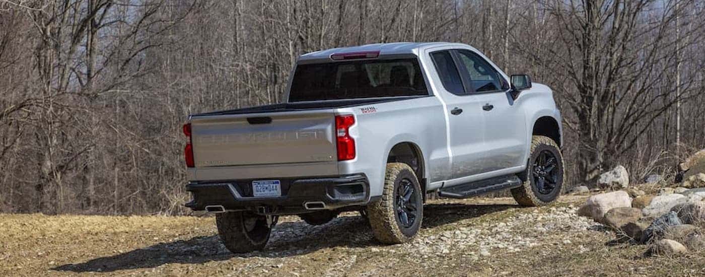 A grey 2025 Chevy Silverado 1500 for sale near Exeter from the rear at an angle.