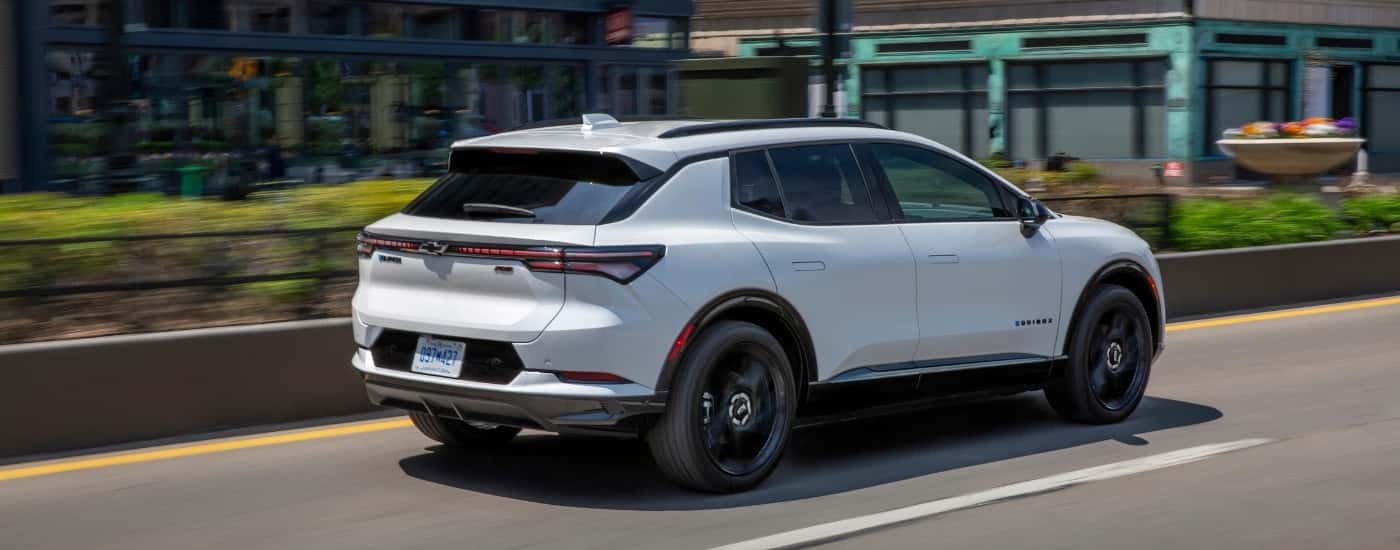 A white 2025 Chevy Equinox EV from the rear at an angle.