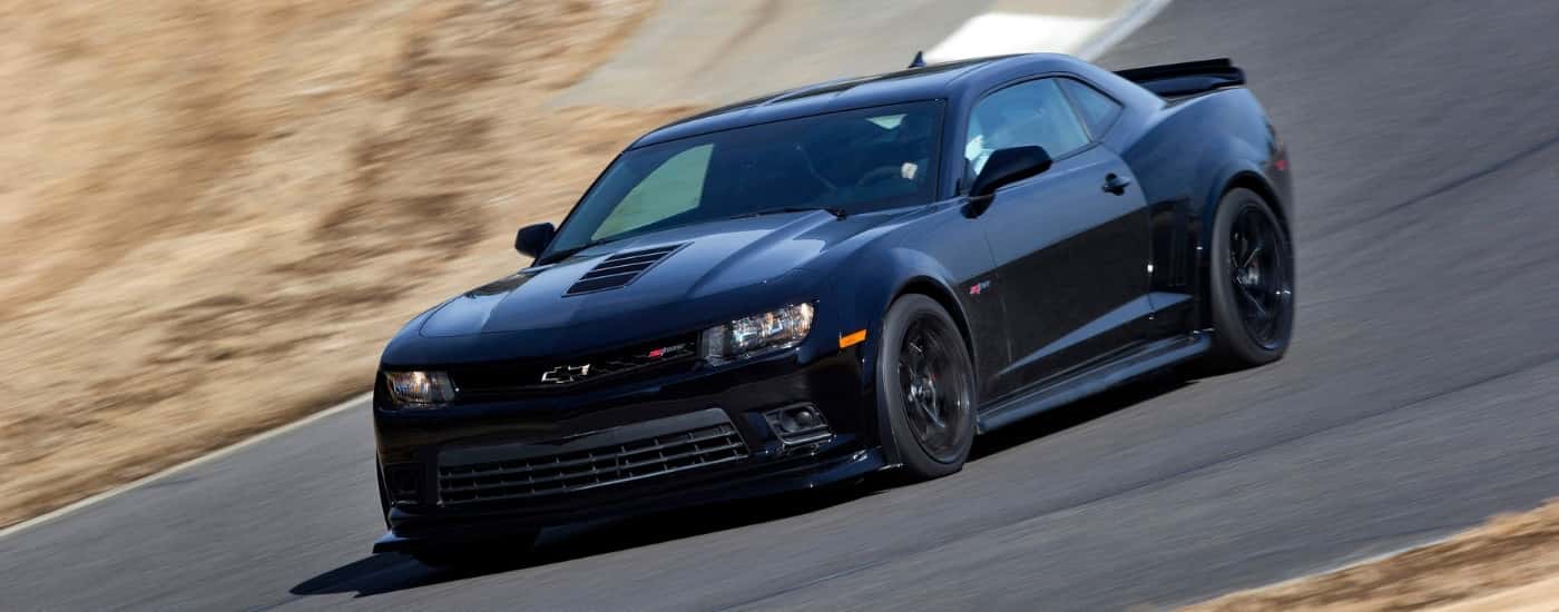 A black 2015 Chevy Camaro Z28 from the front after leaving a dealer that has a used Chevy for sale.