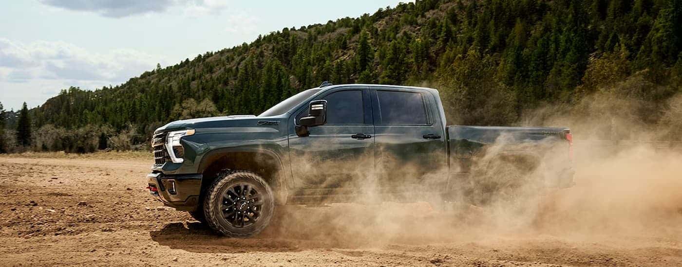 A green 2026 Chevy Silverado 2500 ZR2 off-roading.