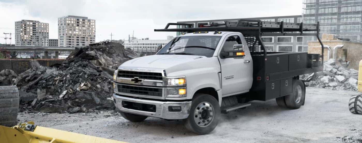 A white 2025 Chevy Silverado 4500 parked on a construction site.