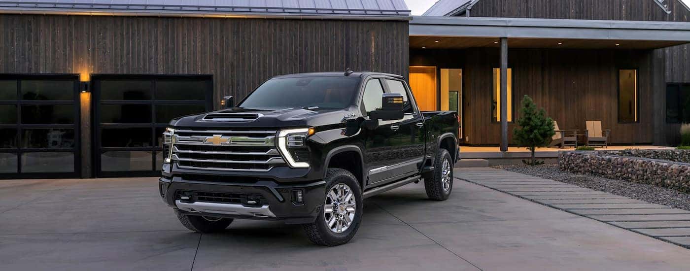 Black 2026 Chevy Silverado 2500 HD for sale near Seabrook parked on a driveway.