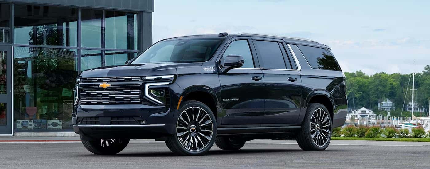 A black 2026 Chevy Suburban High Country parked off-road
