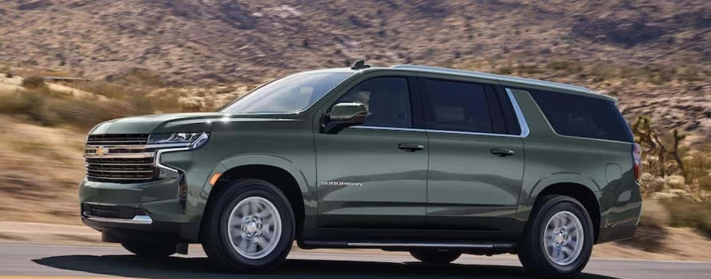 Green 2024 Chevy Suburban on an open road