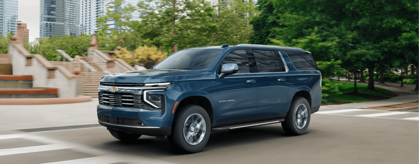 Blue 2026 Chevy Suburban rounding a corner