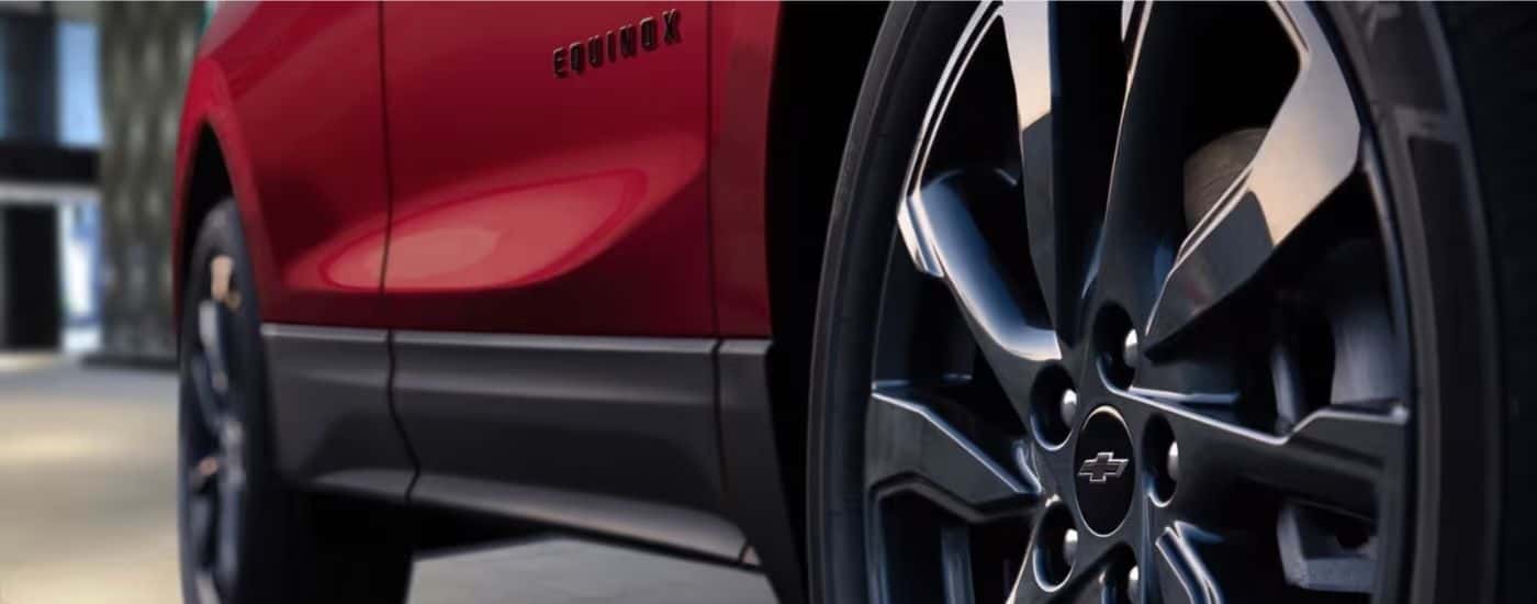 Black wheels on a red 2023 Chevy Equinox RS