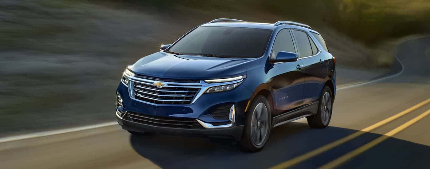 Blue 2022 Chevy Equinox driving along an open road