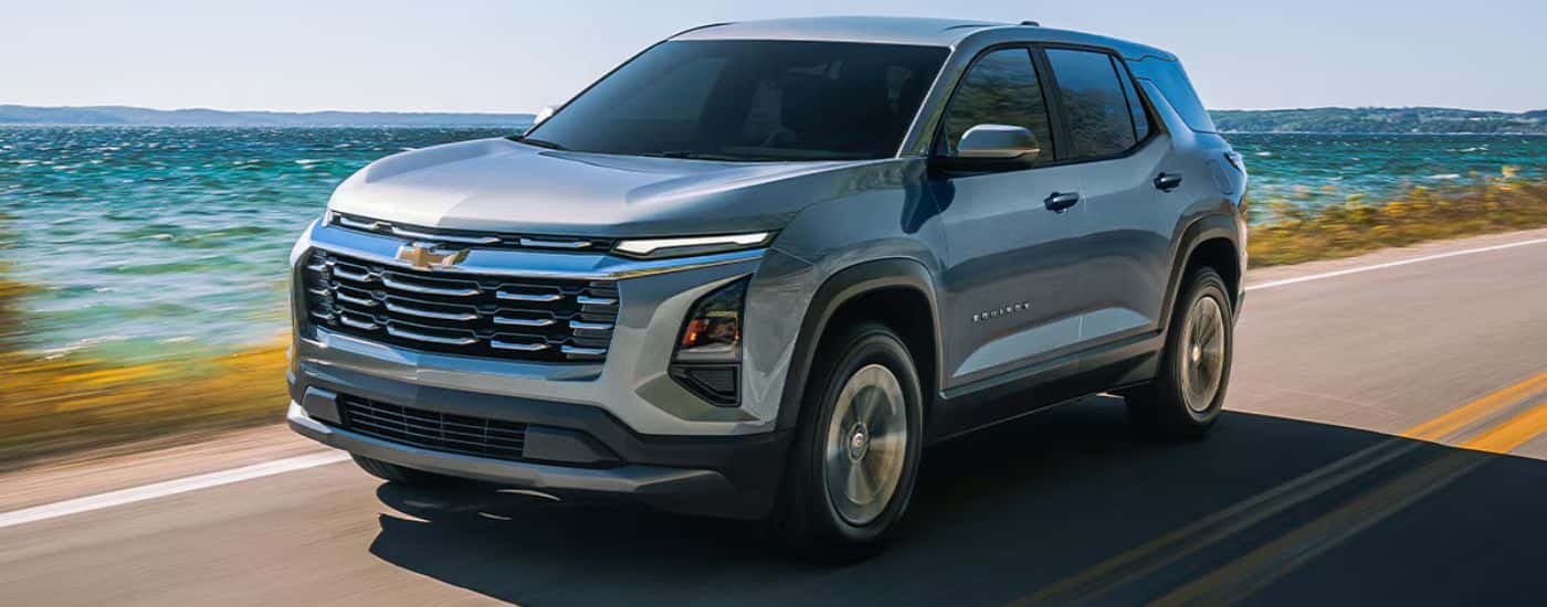 Grey 2026 Chevy Equinox driving along the coast.