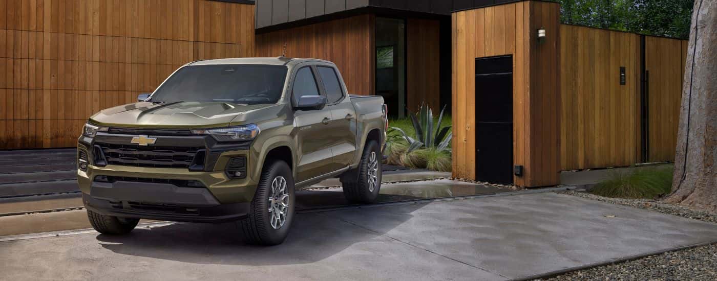A green 2023 Chevy Colorado LT parked in a driveway.