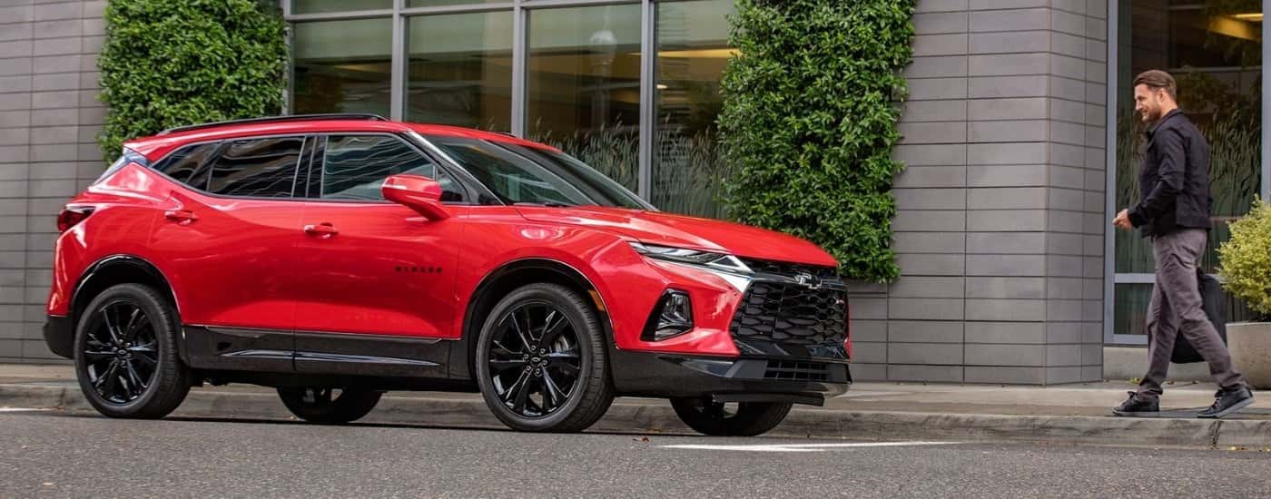 A red 2020 Chevy Blazer RS parked next to a building.