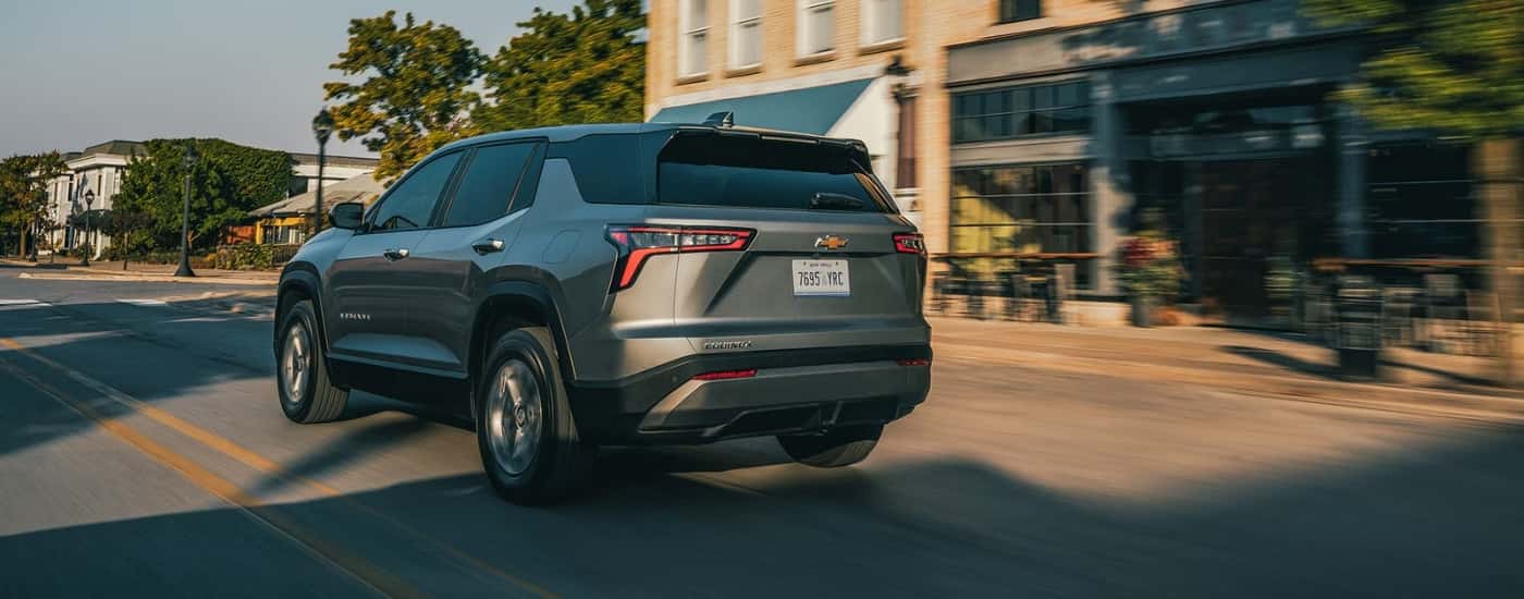 A gray 2026 Chevy Equinox LT shown driving from rear.