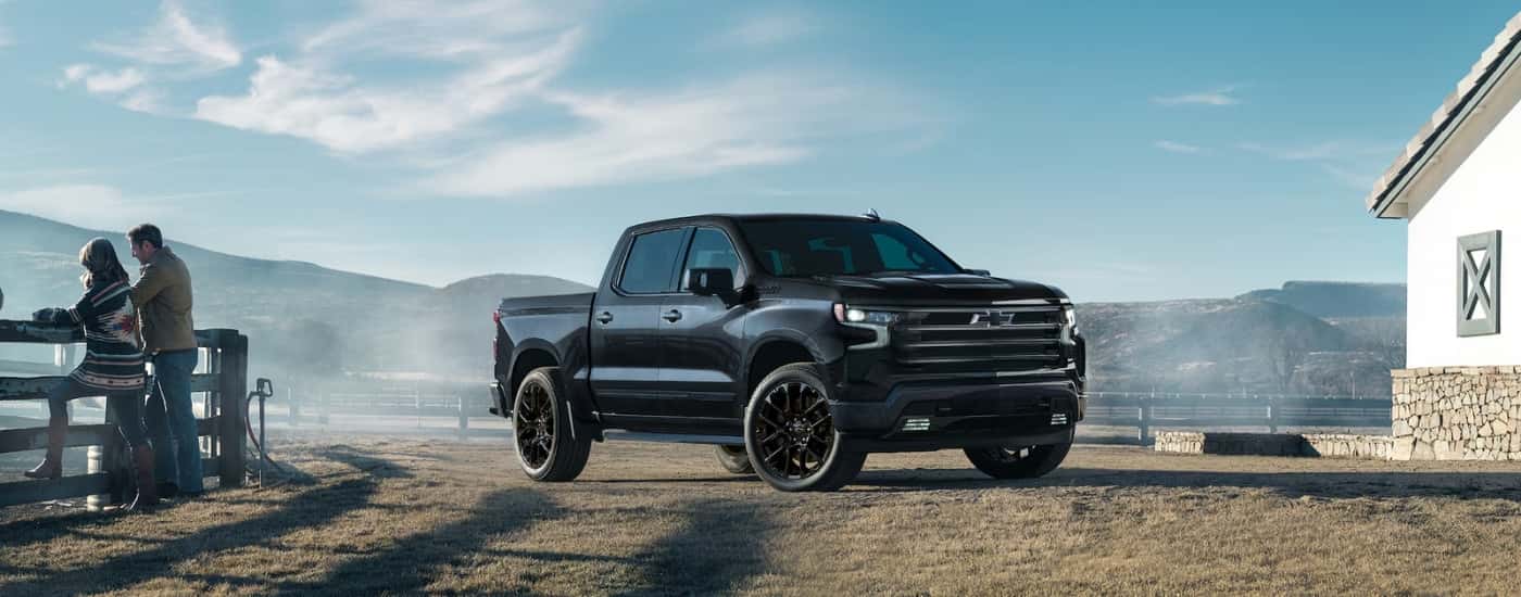 A black 2025 Chevy Silverado 1500 High Country parked on a ranch.