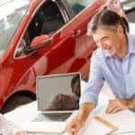 an angle of smiling couple with a salesman
