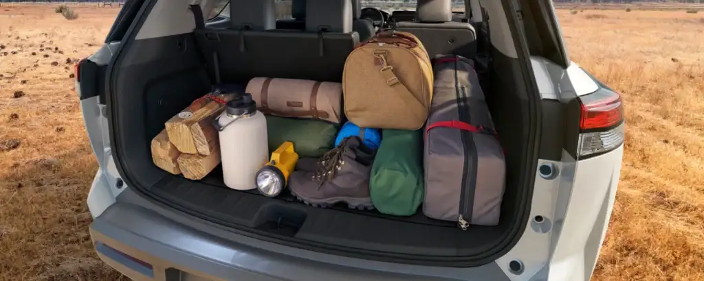 open truck of a nissan pathfinder filled with cargo and suitcases