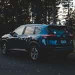 nissan rogue parked in a wooded area