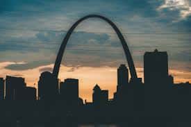 sunset behind the st louis arch