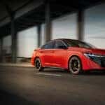 red 2026 nissan sentra driving under overpass