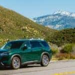 green nissan pathfinder in mountains