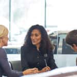Customers speaking with Mazda sales team member