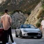 2026 Mazda MX-5 Miata on a mountain road with two people nearby