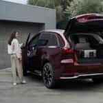 Black 2026 Mazda CX-90 with the back hatch open and two people on the outside.