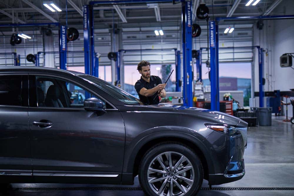 Mazda service technician installing wipers