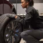Mazda service technician rotating tires
