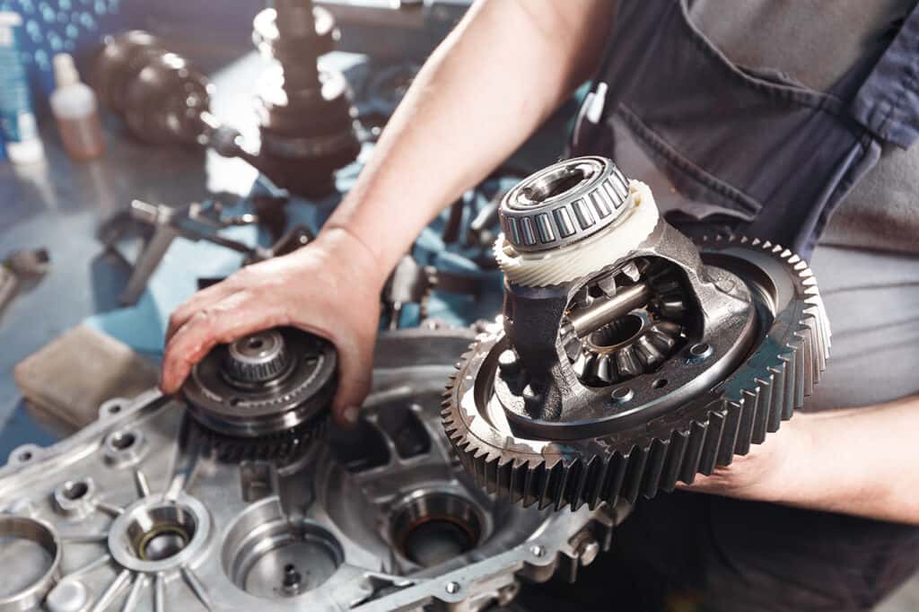 Mazda service technician working on a transmission