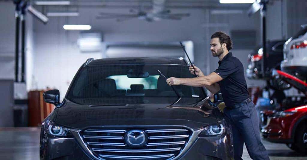 Mazda service technician installing new windshield wipers
