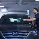 Mazda service technician installing new windshield wipers