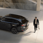 Man walking near a parked 2026 Mazda CX-70
