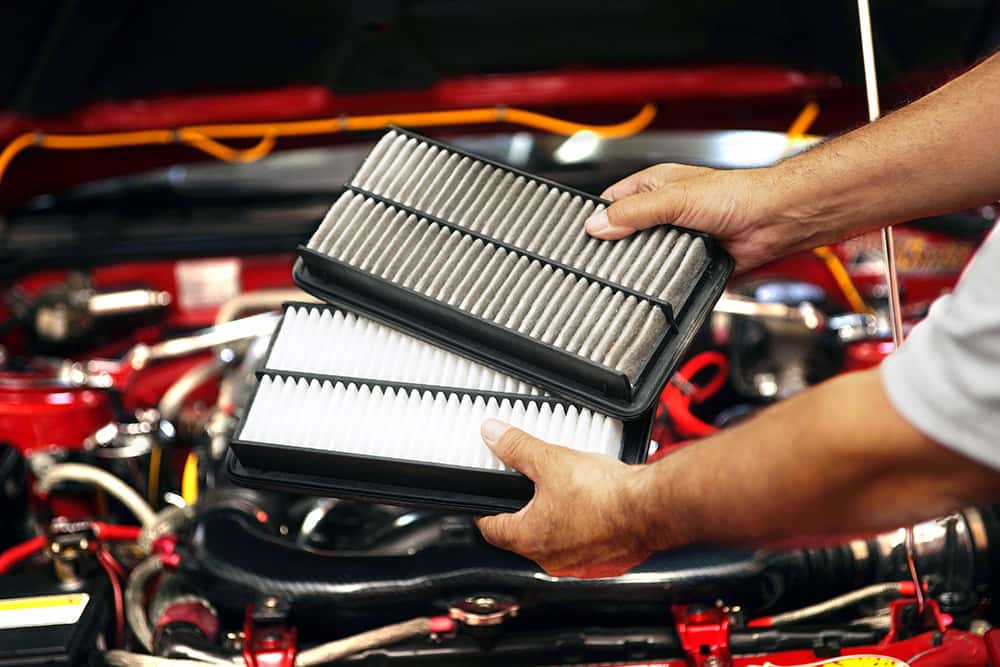 Inspecting engine air filter as part of a Mazda service schedule