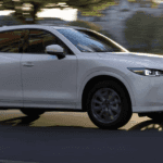 Profile of a pre-owned Mazda SUV on the road