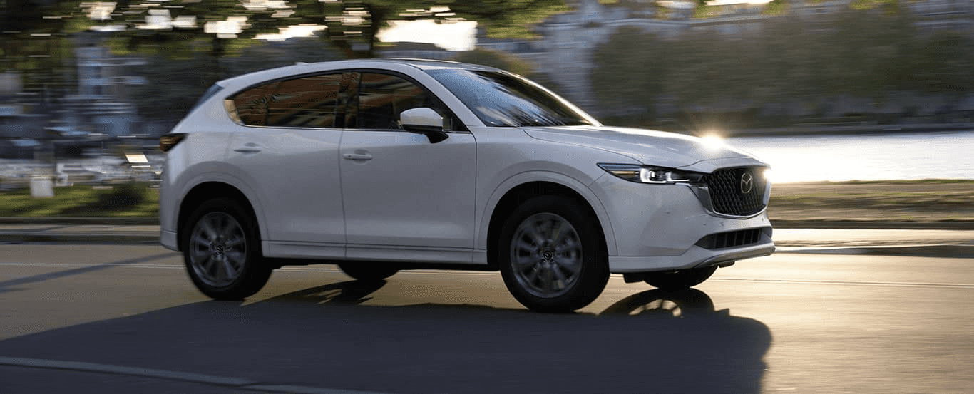 Profile of a pre-owned Mazda SUV on the road