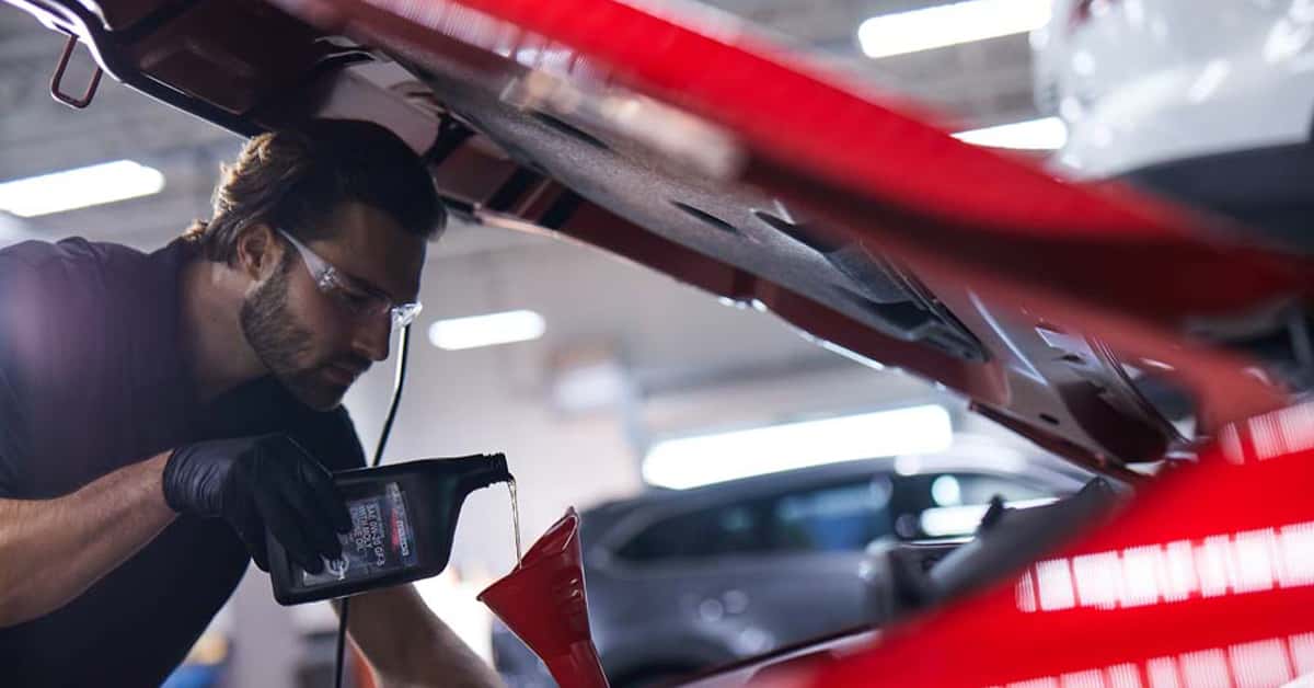 Mazda technician performing a synthetic oil change