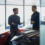 Customer speaking to salesperson at a Mazda dealership