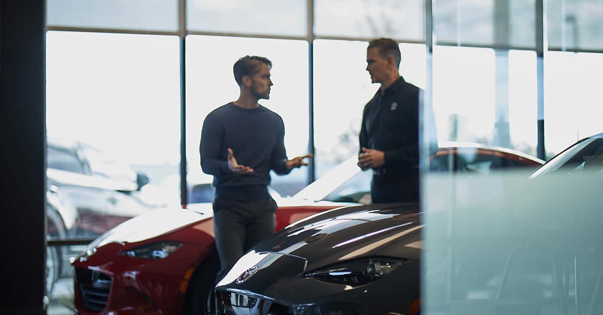 Customer speaking to salesperson at a Mazda dealership