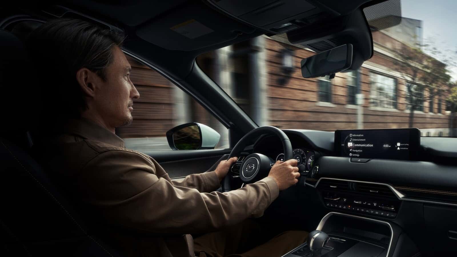 Person driving vehicle equipped with Mazda safety features