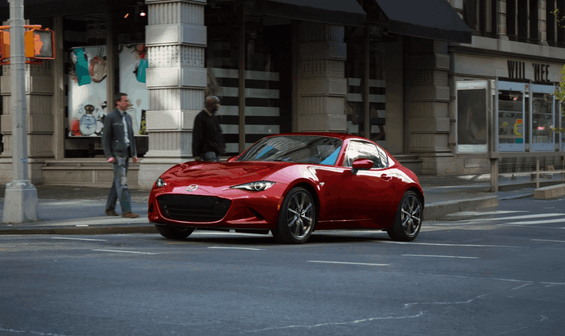 2026 MAZDA MX-5 Miata RF Being Driven at an Intersection