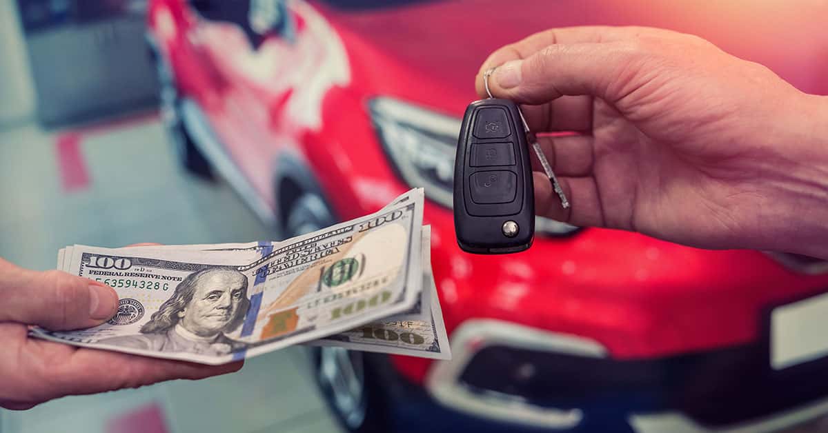 Exchanging cash and keys as part of a Mazda trade-in
