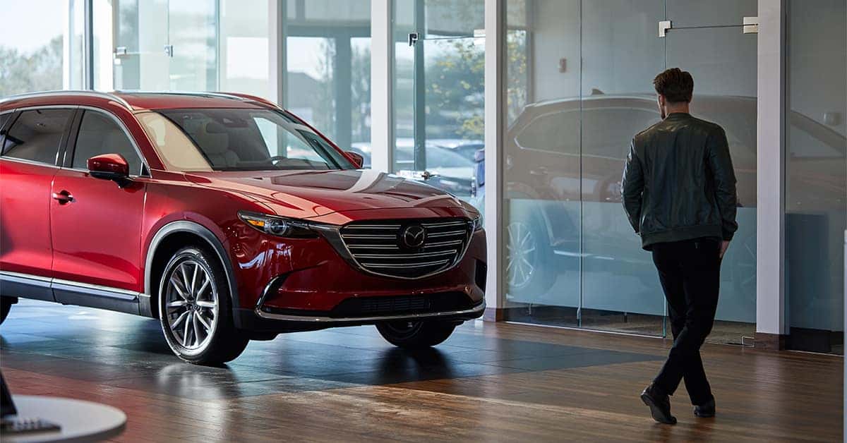 Customer looking at a Mazda Certified Pre-Owned vehicle in dealership