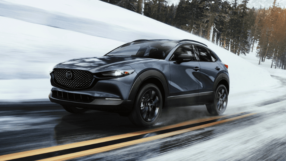 2026 Mazda CX-30 driving on a wet road demonstrating i-Activ AWD handling