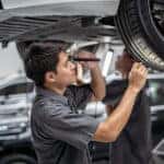 Technician inspecting Mazda tires