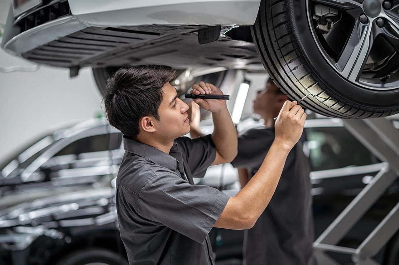 Technician inspecting Mazda tires
