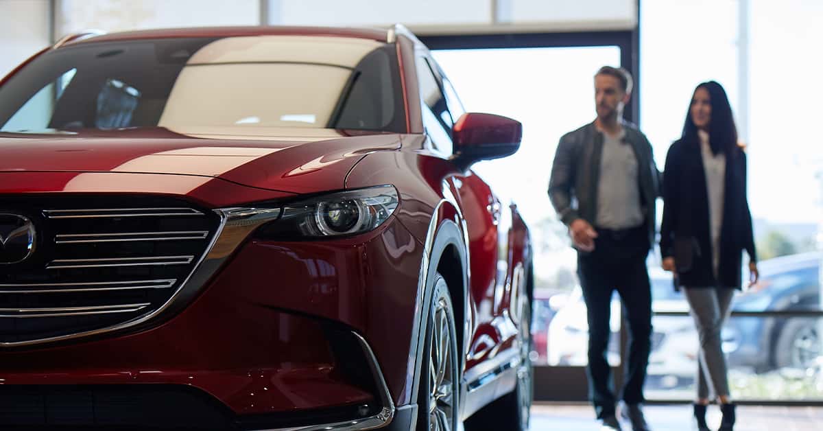 Customer speaking with salesperson about a Mazda lease