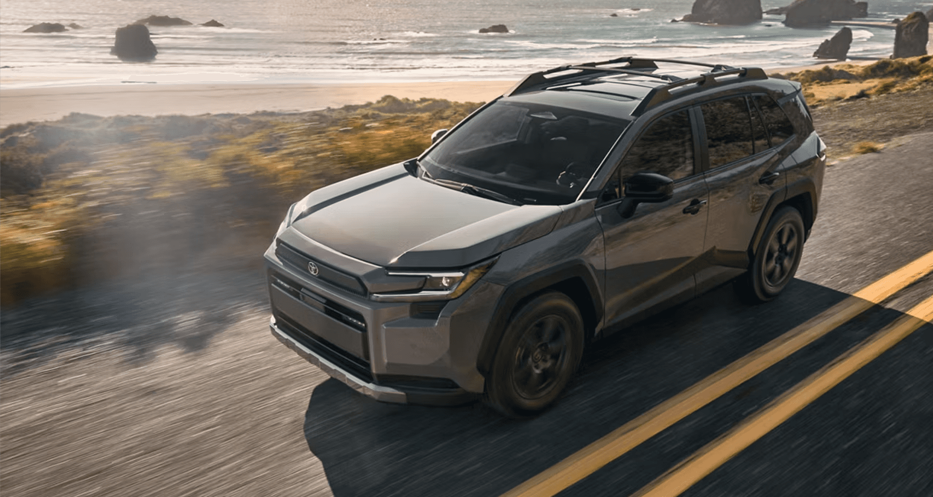 2026 Toyota RAV4 Hybrid hero image showcasing the exterior in a scenic environment